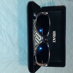 Versace with original medusa embossed case.